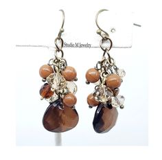 Shades Of Brown Cluster Earrings, Neutral Browns Charm Earrings, Lightweight Earrings, Holiday Jewelry Gift, Fall Autumn Dangles  6mm and 8mm mix brown glass and champagne crystal cluster charm earrings with 15x16mm dark brown resin dangle. Bronze french hook ear wires and are 2" long. #E285 Wanna See More? Click below for other items available: http://www.etsy.com/shop/StudioMJewelry Shipping: All jewelry pieces are ready to ship. Items are shipped to your Etsy address, via USPS First Class mai Shades Of Brown, Lightweight Earrings, Holiday Jewelry, Cluster Earrings, Light Weight Earrings, Crystal Cluster, Charm Earrings, Fall Autumn, Jewelry Gift