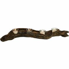 three tealight candles are placed on a piece of driftwood that has been turned into a branch