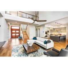 a living room filled with furniture next to a wooden floor