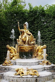 a golden statue sitting on top of a fountain