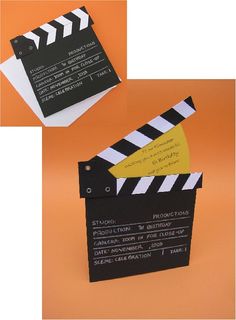 a black and white movie clapper on an orange background with some yellow stickers