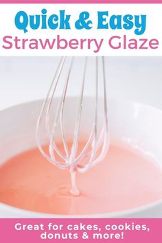 a white bowl filled with strawberry glaze next to a whisk on top of it