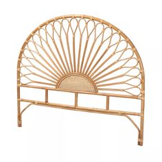 a bed frame made out of bamboo with a sun design on the headboard and foot board