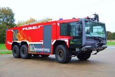 a red and black fire truck parked on the street