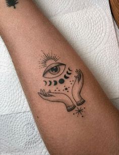 a person with a tattoo on their arm that has an all seeing eye in it