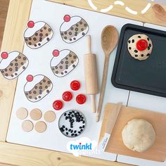 a wooden tray topped with doughnuts next to a baking pan and spatula