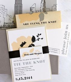 the wedding stationery is laid out on top of each other