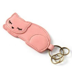 a pink key chain with an eye patch on it