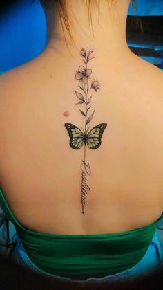 the back of a woman's neck with a butterfly on it