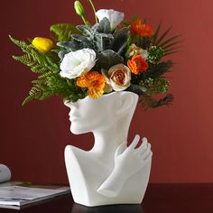 a vase with flowers in it sitting on a table