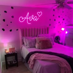 a bedroom with pink walls and black hearts on the wall