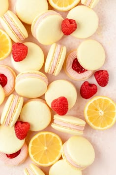 lemons, raspberries and macaroni shells are arranged on a white surface