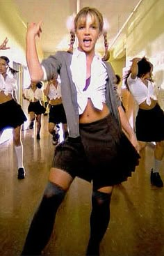 a group of young women dancing in school uniforms