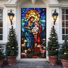 a stained glass door with christmas trees and potted evergreens in front of it