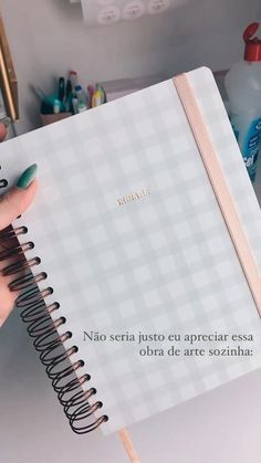 a person holding a notebook with writing on it