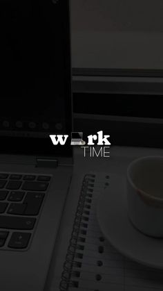 a laptop computer sitting on top of a desk next to a cup and saucer