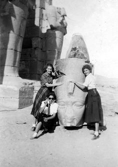 an old black and white photo of some women posing in front of the great sphinx