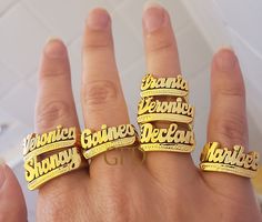 A name ring is a unique and personal way to express your identity and style. Whether you want to wear your own name, a loved one's name, or a meaningful word, you can customize your ring with up to 10 letters in a beautiful script font. The ring is made of high-quality sterling silver with a choice of gold or rose gold overlay for a stunning finish. The ring comes in a lovely gift box and is available in different sizes. A name ring is a perfect gift for yourself or someone special on any occasi Engraved Nameplate Ring For Promise, Promise Ring With Custom Nameplate, Customized Nameplate Rings For Anniversary, Customized Gold Open Ring, Custom Name Plate Ring For Promise, Custom Name Adjustable Nameplate Ring, Gold Engraved Name Ring For Promise, Custom Nameplate Rings For Promise, Silver Nameplate Ring With Custom Name