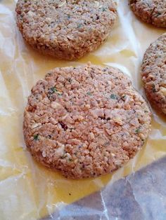 four hamburger patties sitting on wax paper