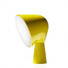 a yellow table lamp with a white light on the top and bottom part of it