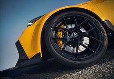 the front wheel of a yellow sports car