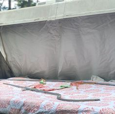 an empty bed in the back of a truck with a canopy over it and tools laying on top