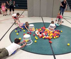 children playing with balls in an indoor gym