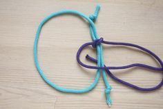 a blue and purple rope on top of a wooden table