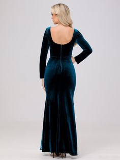 the back of a woman wearing a long velvet dress