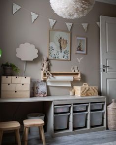 a child's playroom with toys and decorations on the wall, including storage bins