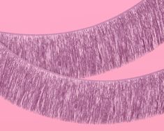 two purple tinsels on a pink background