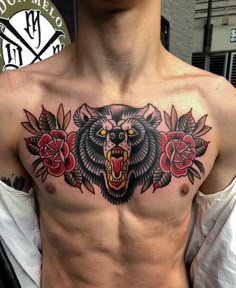 a man with a bear and roses tattoo on his chest