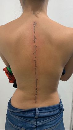 the back of a woman's upper body with writing on her left shoulder and lower back