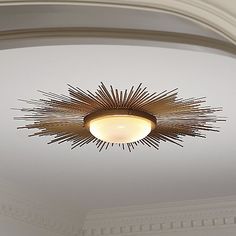 a ceiling light that is on in the middle of a room with white walls and ceilings