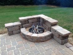 a fire pit sitting on top of a brick patio