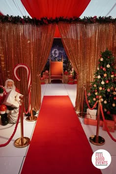 a red carpeted hallway with gold drapes and christmas decorations