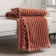 a bed with a blanket and pillows on top of it