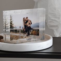 an acrylic photo on a plate with pine cones