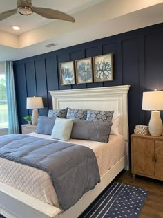 a bedroom with blue walls and white bedding