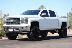 a white truck parked on the side of a road