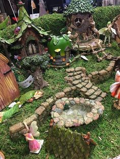 a fairy garden with lots of green plants and small houses