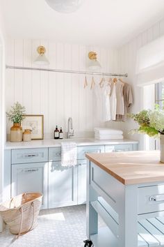 a kitchen with blue cabinets and white walls