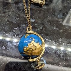 This Globe Necklace Is Perfect For The Avid Traveler! This Tiny Globe Actually Spins In Its Mount So You Can Look At All The Places You Want To Visit While You're On The Go! There's Even A Tiny Set Of Binoculars On The Necklace To Add To The Adventurers' Feel. The Necklace Has An Antiqued Brass Finish And Is Still In Its Packaging. Happy Poshing!! Spinning Globe, Globe Necklace, Brass Finish, Binoculars, Blue Gold, Antique Brass, Womens Jewelry Necklace, Spinning, The Go