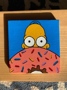 a painting of a simpsons holding a donut with sprinkles on it