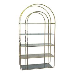 a gold metal shelf with three shelves on each side and two glass shelves in the middle