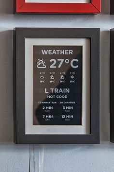 three framed signs on the wall displaying weather and train times in different colors, sizes and shapes