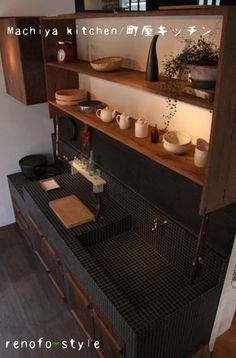 a kitchen with wooden shelves filled with pots and pans