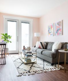 a living room with pink walls and furniture