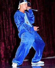 a male in a blue outfit is on stage