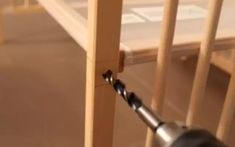 a screwdriver is attached to the side of a baby crib